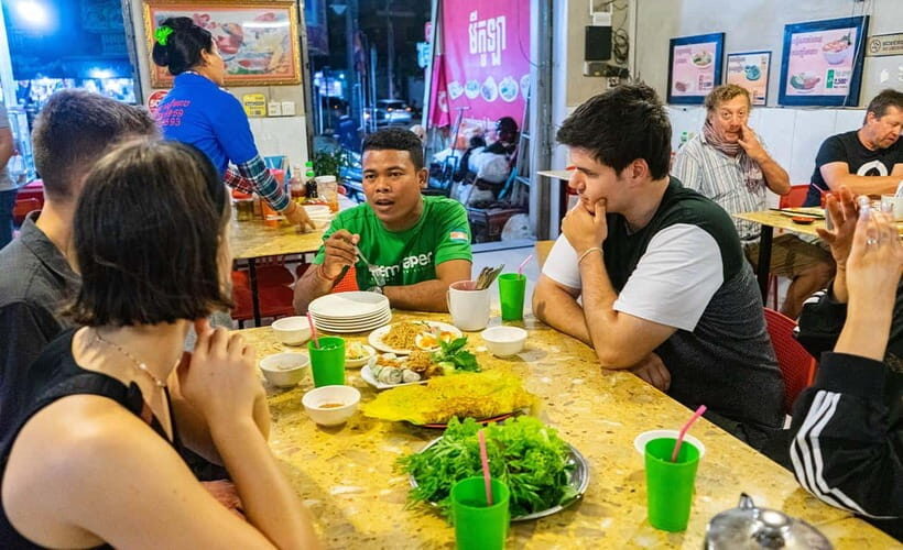 Phnom Penh: Evening Food Tour with Drinks & Tuk Tuk Included - Riverfront snacking: what it feels like when the city slows down